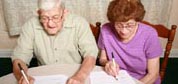 Photo: Elderly couple doing paperwork