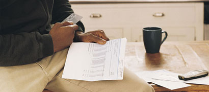 Man with credit card bill (h)