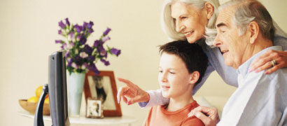 Grandparents and grandson looking at computer (h)